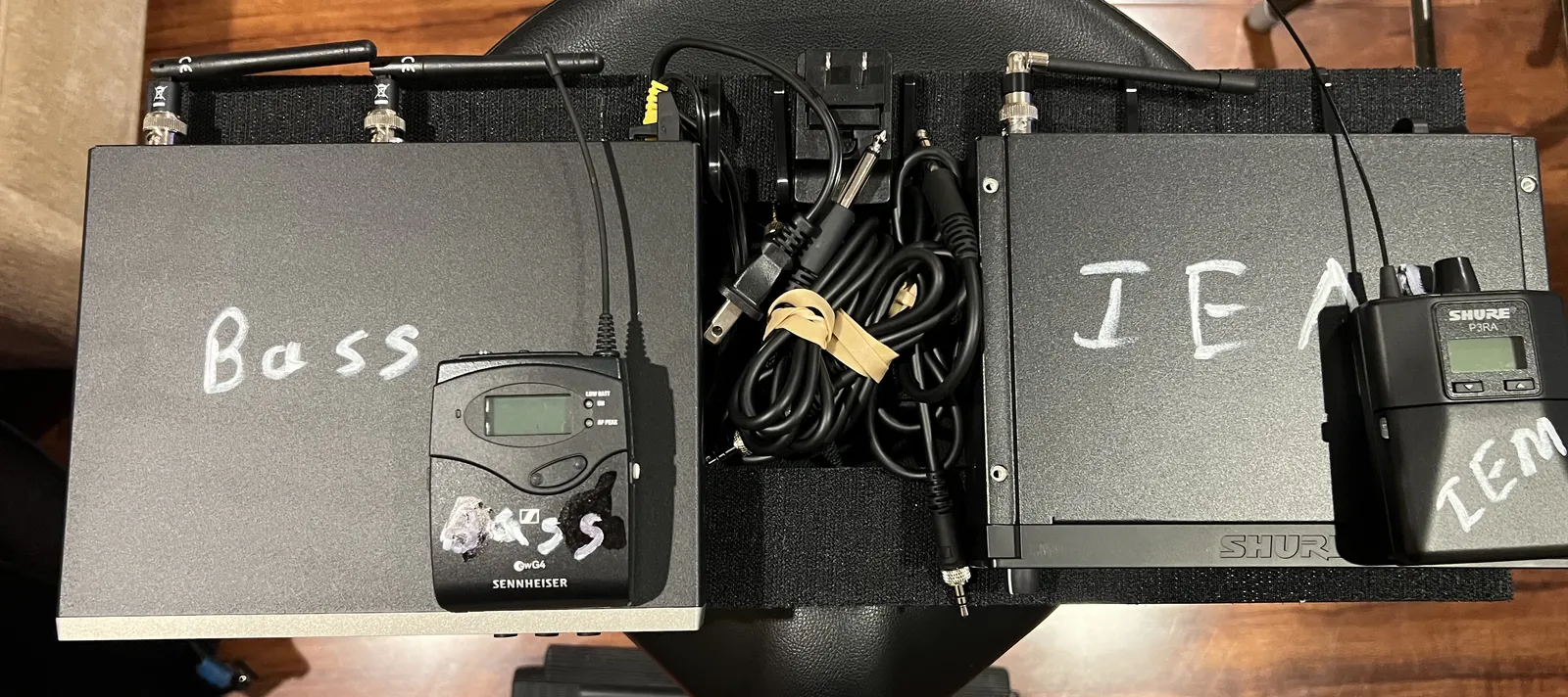 The wireless rig, with Sennheiser and Shure wireless bodypacks and cases marked Bass and IEM