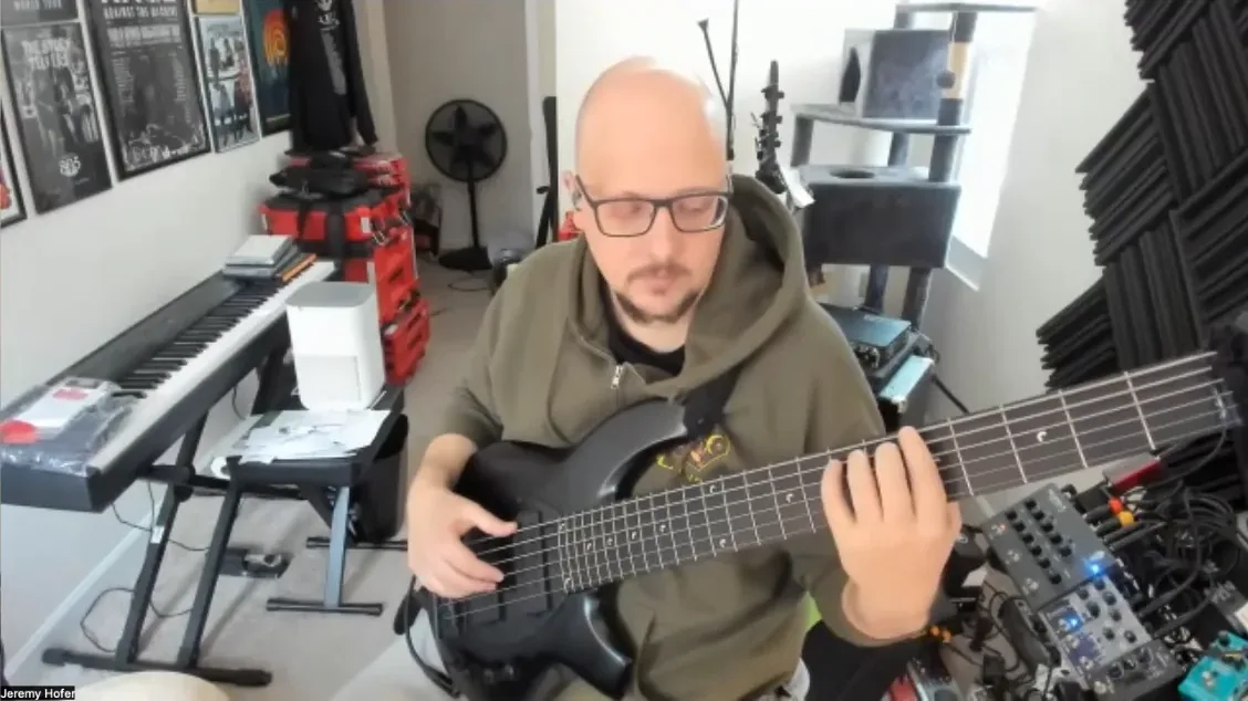 A student on the same Zoom call, bass in hand at home