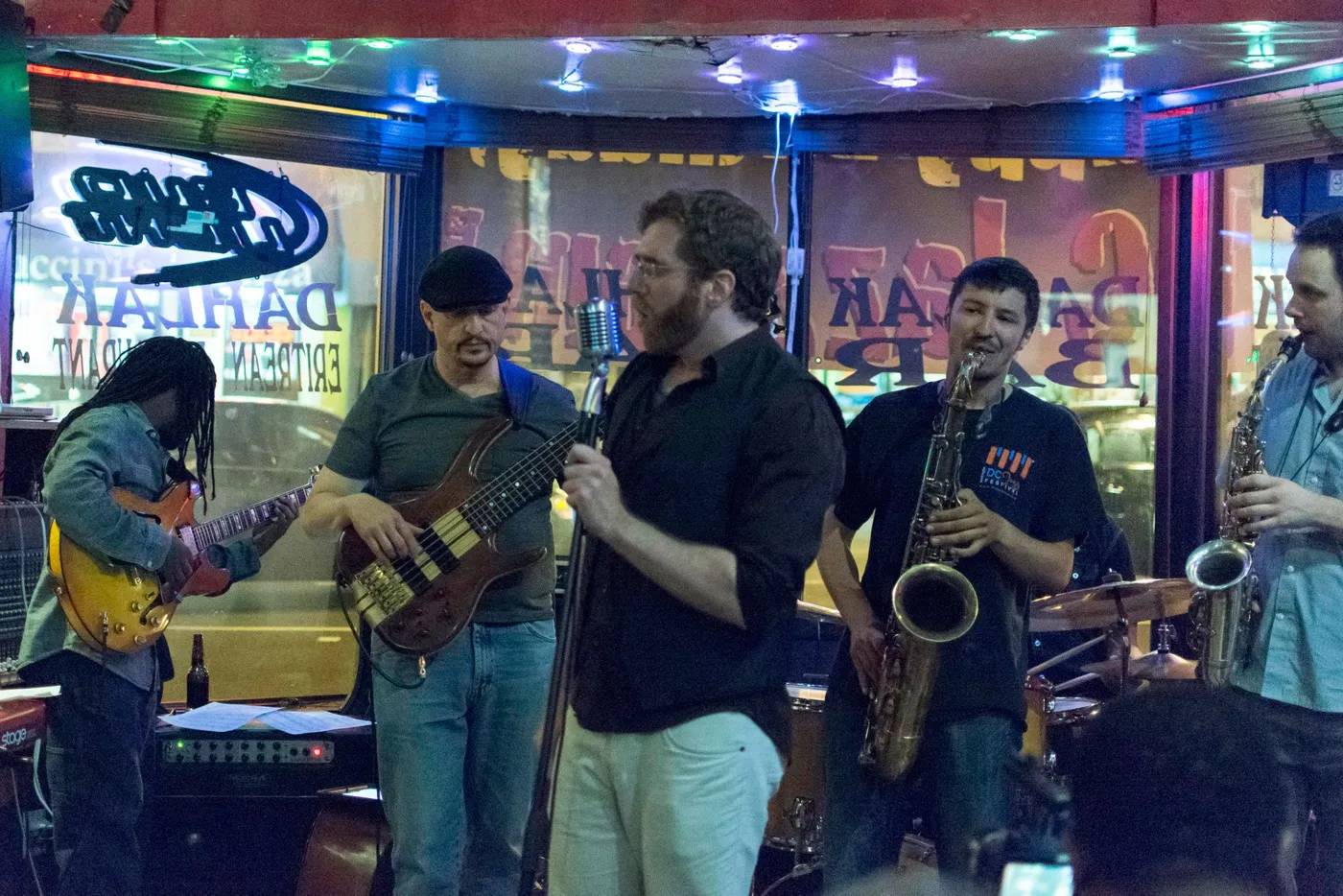 Russ Rodgers on bass with his band under colorful stage lighting