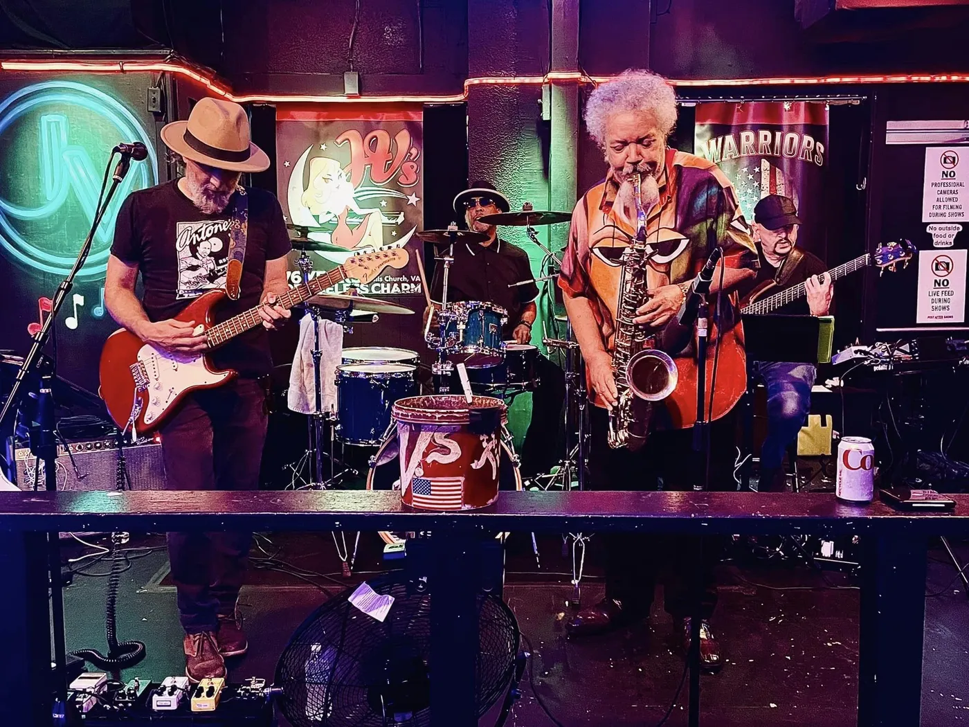 Russ Rodgers playing bass in a band with a saxophone player