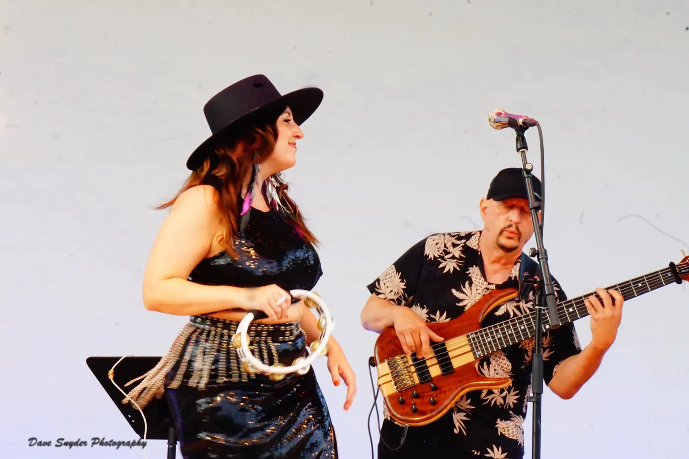 Russ Rodgers playing bass beside a vocalist in a hat