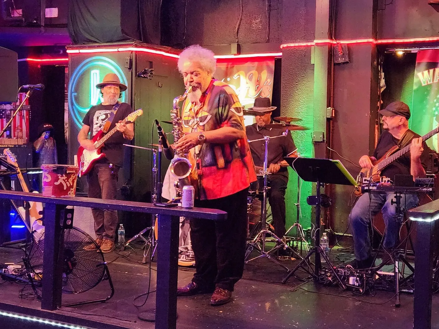Russ Rodgers performing on stage with a full band