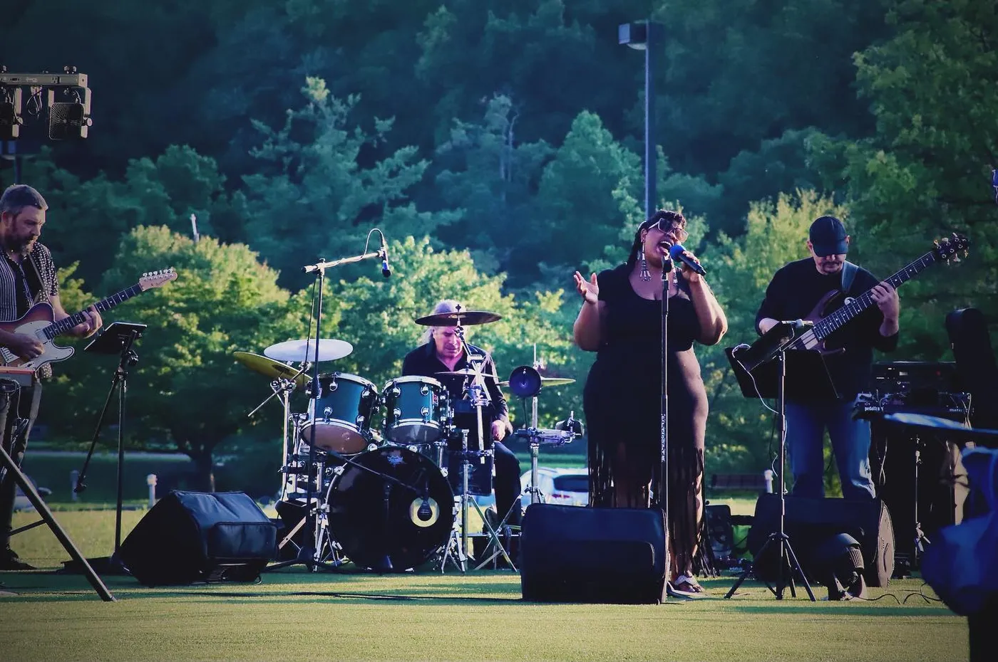 Russ Rodgers playing bass with a band at an outdoor festival