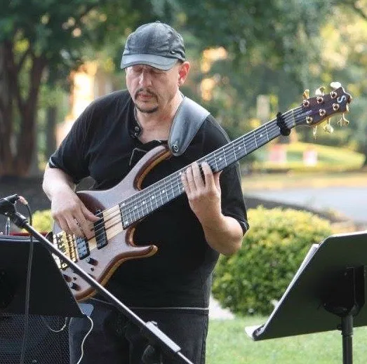 Russ Rodgers playing bass at an outdoor performance