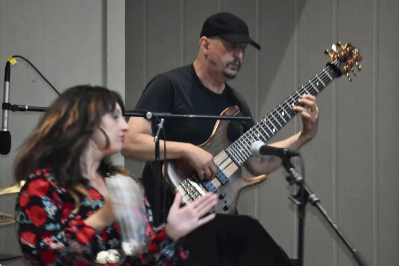 Russ Rodgers backing a vocalist on bass during a live set